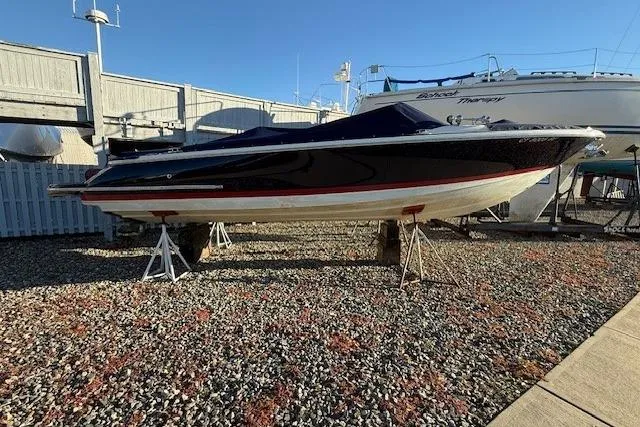 Slide: The Image of 2014 Chris-Craft Launch 25 boat on stands in a gravel yard. - 69