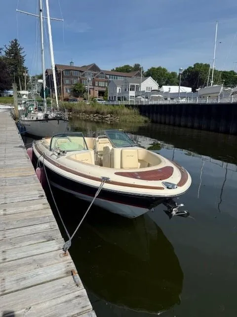 Slide: The Image of 2014 Chris-Craft Launch 25 boat docked in a serene marina setting. - 7