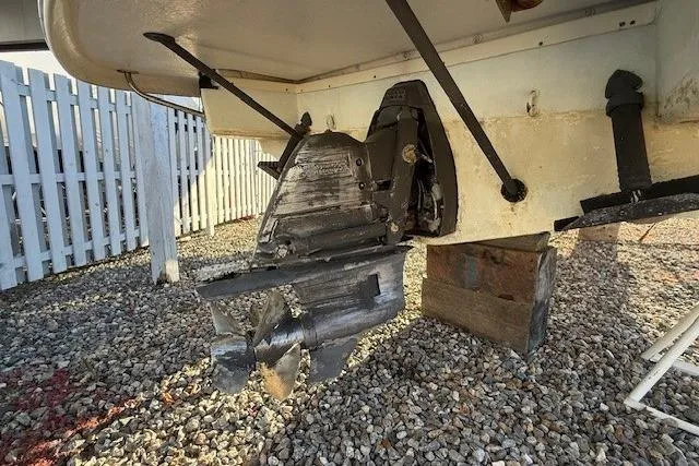 Slide: The Image of 2014 Chris-Craft Launch 25 boat propeller and stern drive on gravel surface. - 70