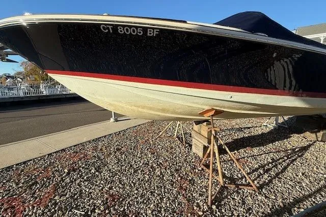 Slide: The Image of 2014 Chris-Craft Launch 25 boat on stands, parked on gravel. - 71