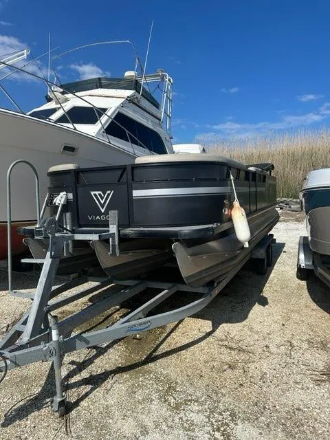 Slide: The Image of 2023 Viaggio Lago R boat on trailer, parked outdoors under blue sky. - 12