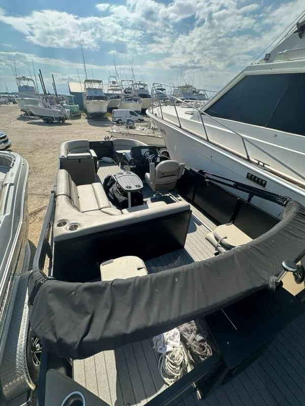 Slide: The Image of 2023 Viaggio Lago R boat docked, featuring spacious seating and modern design. - 14