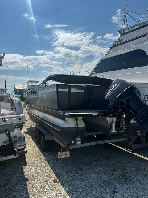 Slide: The Image of 2023 Viaggio Lago R boat with Suzuki engine on trailer, parked in marina. - 15