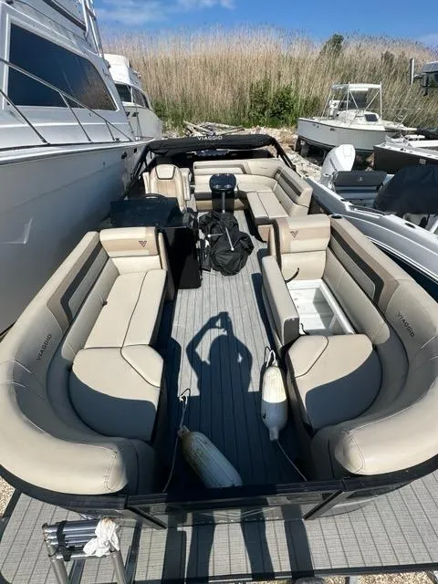 Slide: The Image of 2023 Viaggio Lago R boat with spacious seating, docked alongside other vessels. - 17