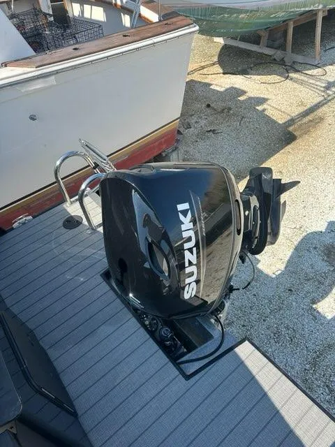 Slide: The Image of 2023 Viaggio Lago R boat with Suzuki outboard motor on dock. - 18