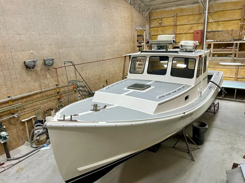 Slide: The Image of 1980 Holland 32 boat in a workshop, showcasing classic design and craftsmanship. - 10