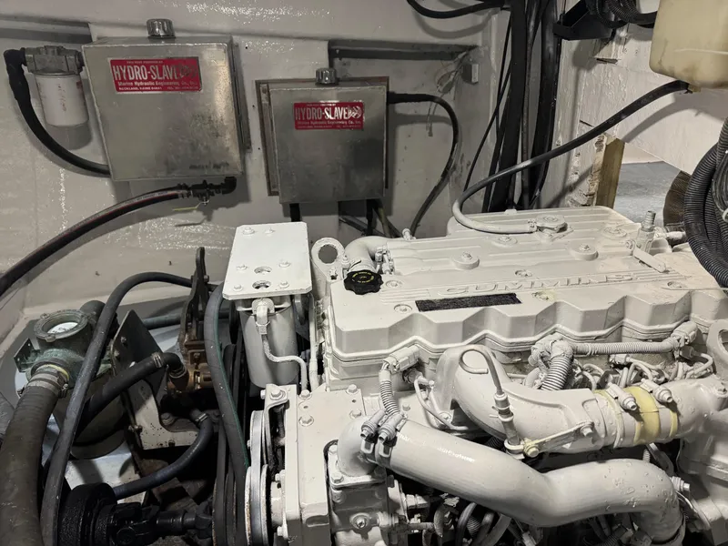 Slide: The Image of Engine room of a 1980 Holland 32 boat, featuring mechanical components and wiring. - 15