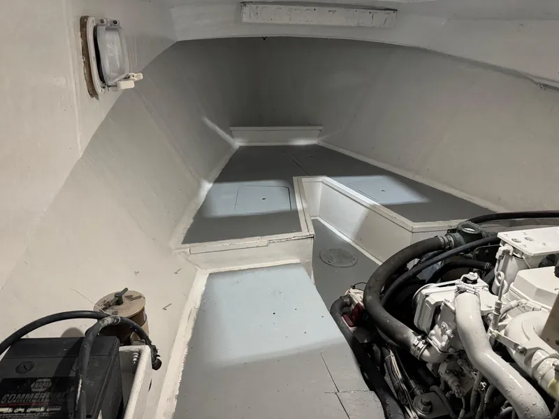 Slide: The Image of Interior of a 1980 Holland 32 boat, featuring engine and storage space. - 16