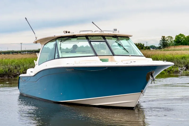 The Image of 2024 Grady-White Freedom 415 boat on calm water, showcasing sleek design and blue hull. - 0