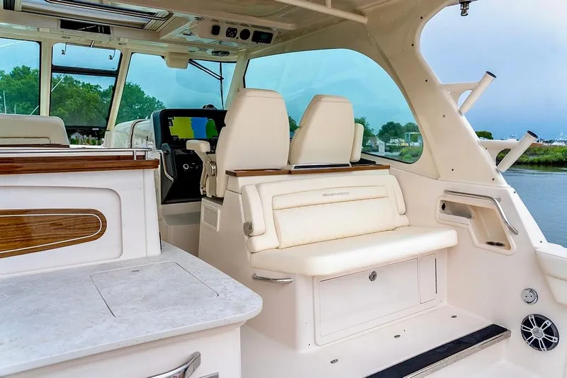 Slide: The Image of 2024 Grady-White Freedom 415 boat interior with luxurious seating and modern dashboard. - 12