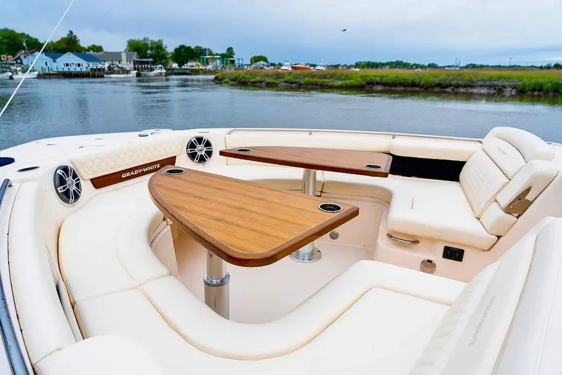 Slide: The Image of 2024 Grady-White Freedom 415 boat interior with elegant seating and wooden table. - 14