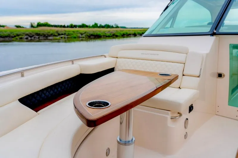 Slide: The Image of Luxurious seating area on 2024 Grady-White Freedom 415 boat with elegant wooden table. - 15