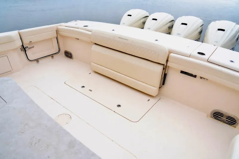 Slide: The Image of 2024 Grady-White Freedom 415 boat deck with seating and multiple outboard engines. - 18