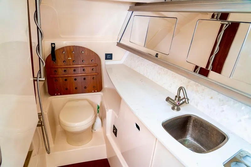 Slide: The Image of 2024 Grady-White Freedom 415 boat bathroom with sink, toilet, and storage. - 19