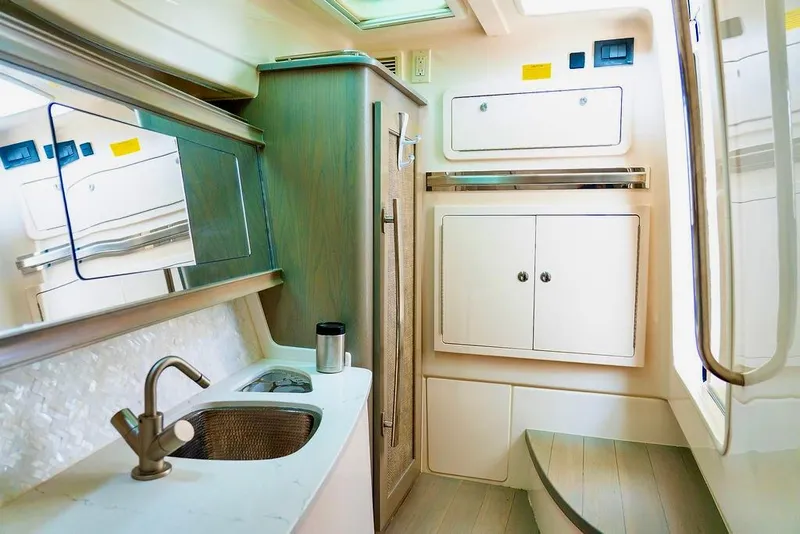 Slide: The Image of 2024 Grady-White Freedom 415 boat interior with sink and storage cabinets. - 20