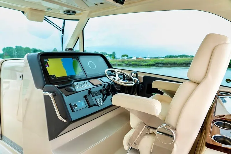 Slide: The Image of 2024 Grady-White Freedom 415 helm with advanced navigation system and luxurious seating. - 5