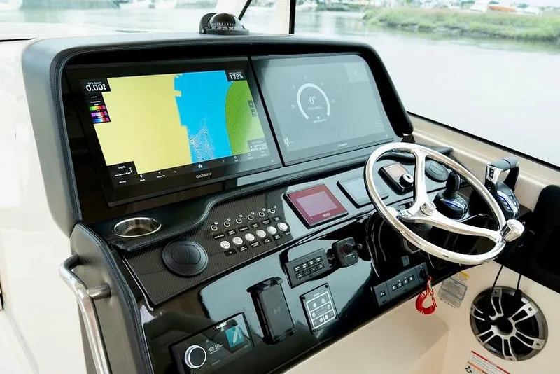 Slide: The Image of 2024 Grady-White Freedom 415 boat dashboard with navigation screens and controls. - 6