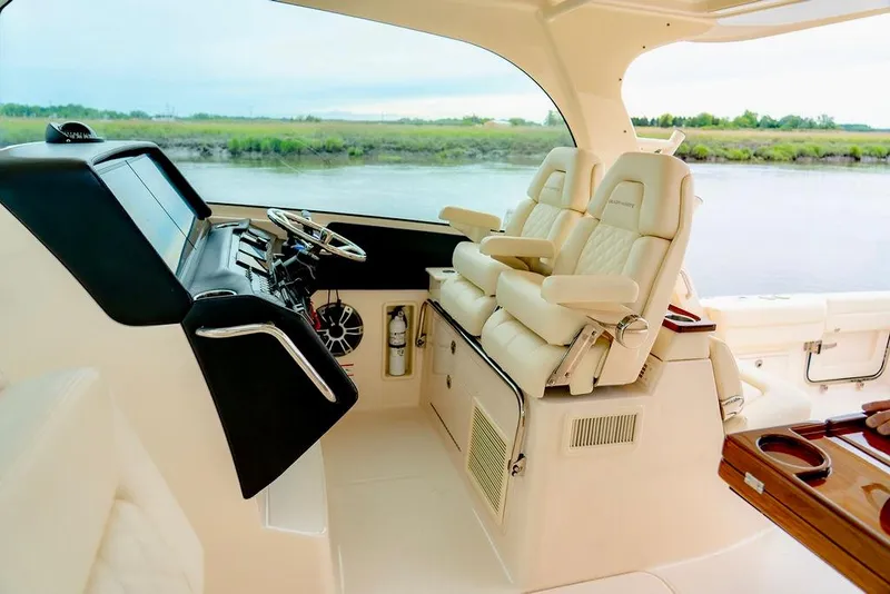Slide: The Image of 2024 Grady-White Freedom 415 boat interior with luxurious seating and modern dashboard. - 7