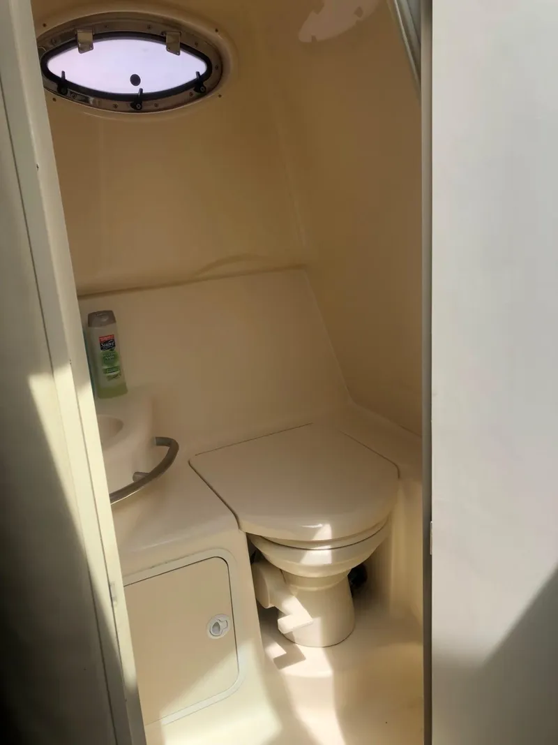 Slide: The Image of 1998 Sea Ray 290 Sundancer boat bathroom with toilet and sink. - 11