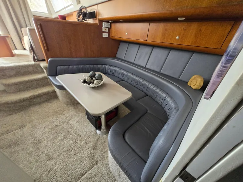 Slide: The Image of 1996 Silverton 37 Convertible interior with curved seating and table. - 15