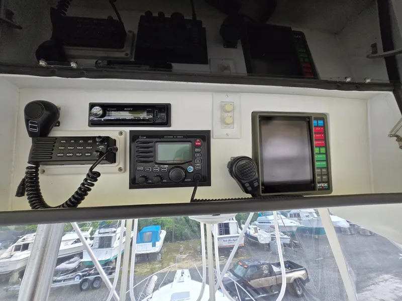Slide: The Image of Control panel of a 1996 Silverton 37 Convertible boat with navigation and communication equipment. - 25