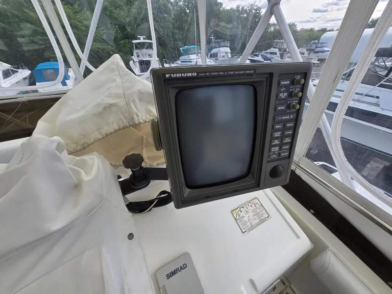 Slide: The Image of 1996 Silverton 37 Convertible boat cockpit with navigation equipment and Furuno display. - 26