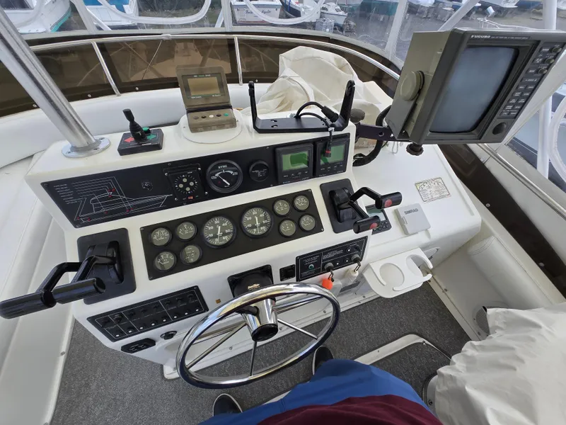 Slide: The Image of Control panel of a 1996 Silverton 37 Convertible boat with navigation instruments. - 29