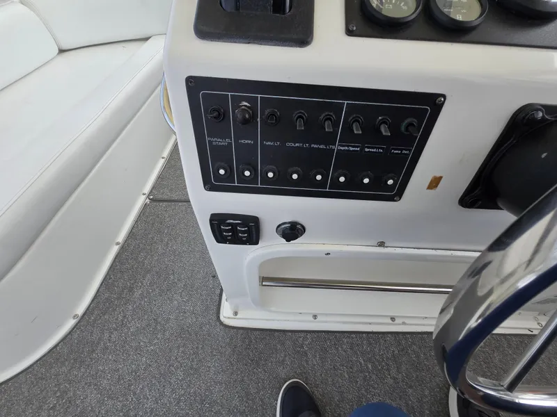 Slide: The Image of Control panel of a 1996 Silverton 37 Convertible boat with switches and gauges. - 30