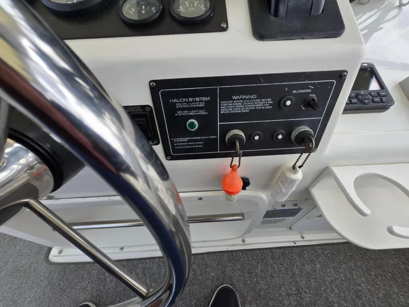 Slide: The Image of Control panel of a 1996 Silverton 37 Convertible boat with steering wheel and gauges. - 31