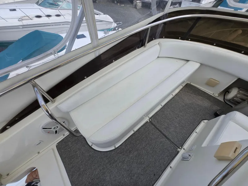 Slide: The Image of 1996 Silverton 37 Convertible boat interior with white seating and gray carpet. - 38