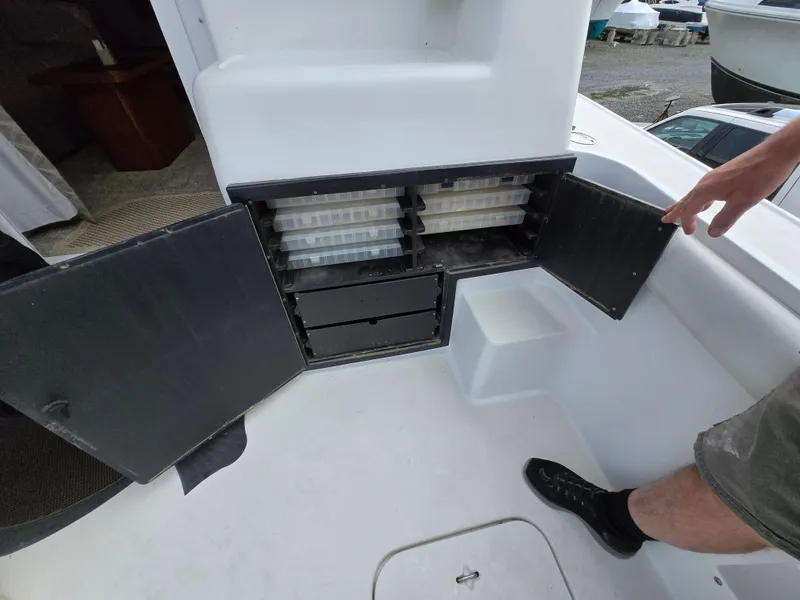 Slide: The Image of 1996 Silverton 37 Convertible boat storage compartment with open doors and visible trays. - 41