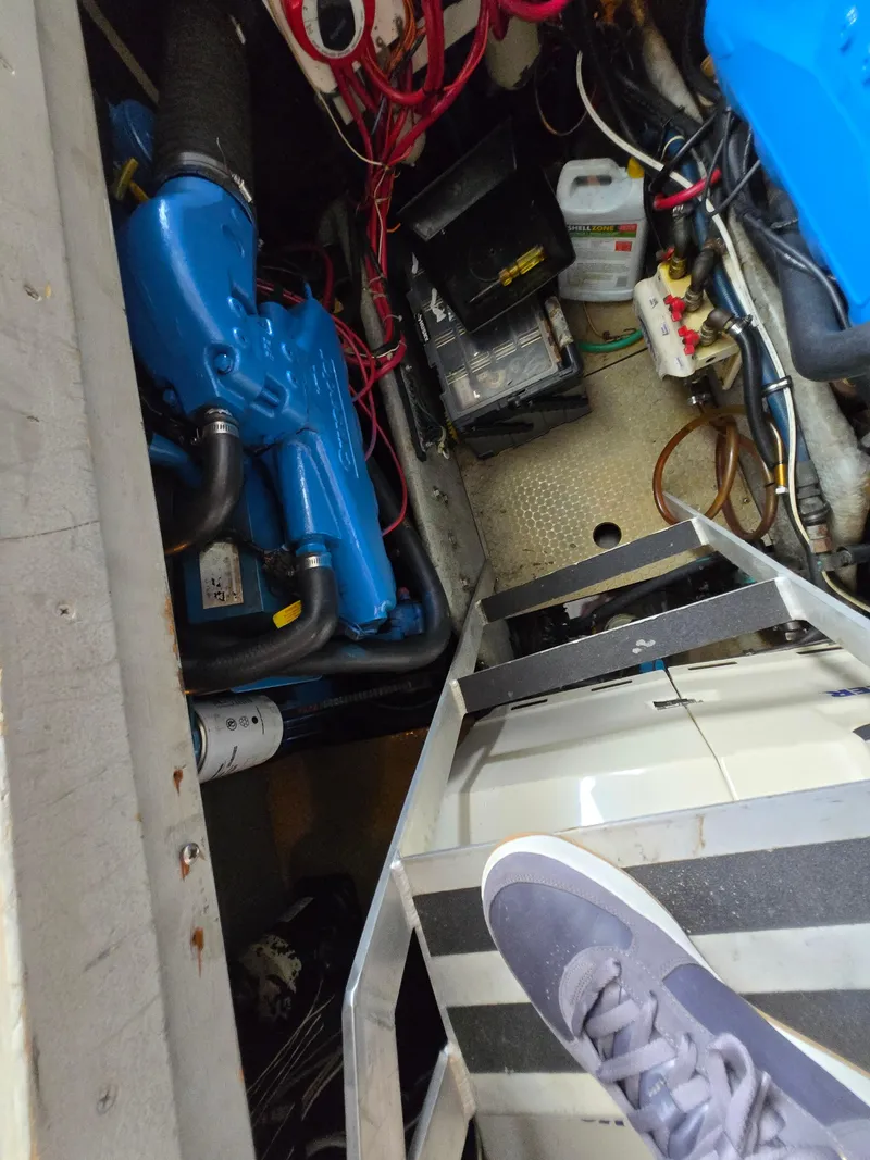 Slide: The Image of Engine room of a 1996 Silverton 37 Convertible boat with visible machinery and wiring. - 43