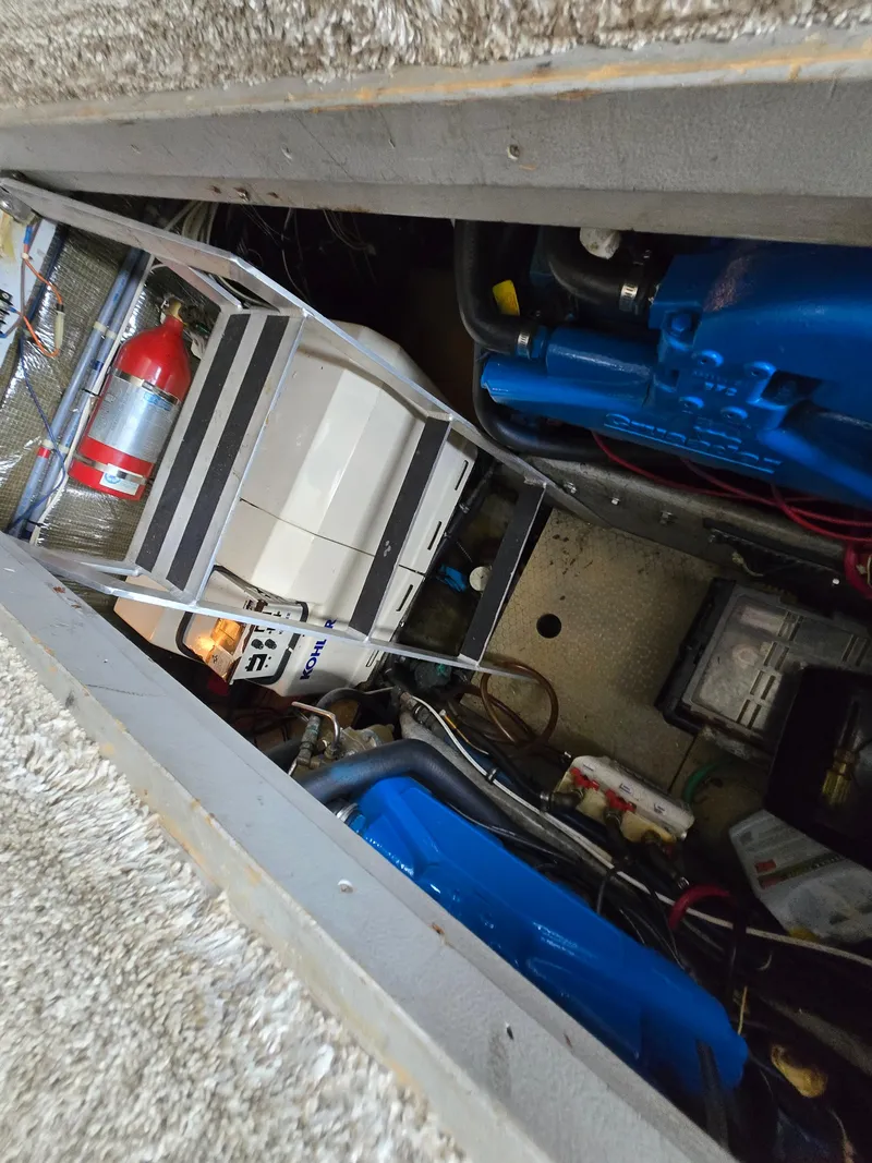 Slide: The Image of Engine compartment of a 1996 Silverton 37 Convertible boat, featuring machinery and equipment. - 45