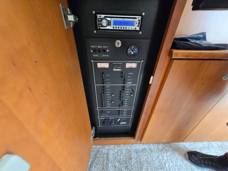 Slide: The Image of Electrical panel inside a 1996 Silverton 37 Convertible boat, featuring controls and a stereo system. - 46