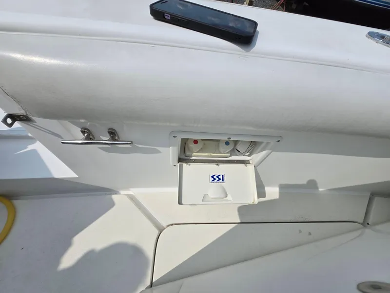 Slide: The Image of 1996 Silverton 37 Convertible boat deck with utility compartment and phone. - 49