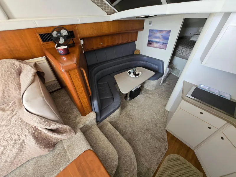 Slide: The Image of Interior of 1996 Silverton 37 Convertible yacht with cozy seating and dining area. - 6