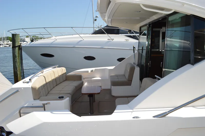 Slide: The Image of 2016 Tiara Yachts C44 Coupe with spacious seating area and sleek design. - 11