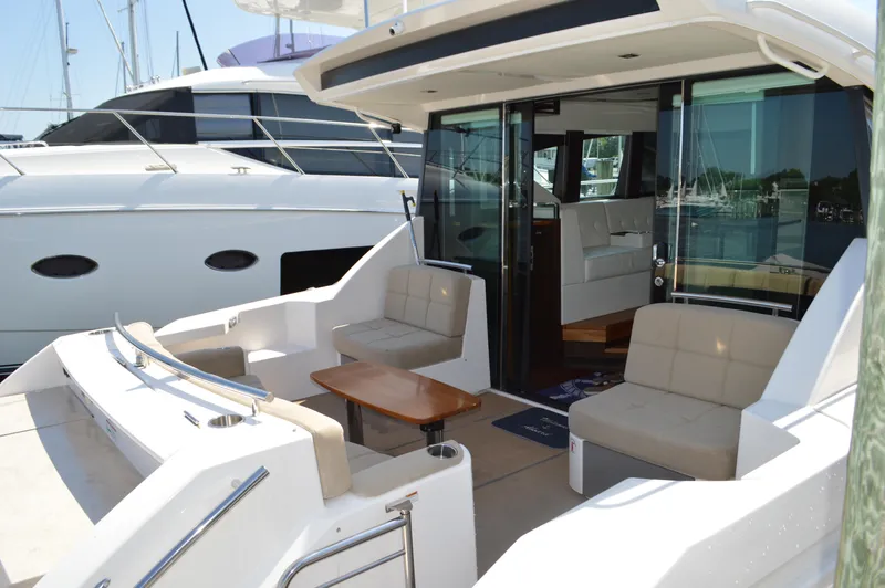 Slide: The Image of 2016 Tiara Yachts C44 Coupe with spacious outdoor seating and elegant interior design. - 12