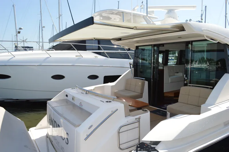 Slide: The Image of 2016 Tiara Yachts C44 Coupe with open deck and luxurious seating at marina. - 16