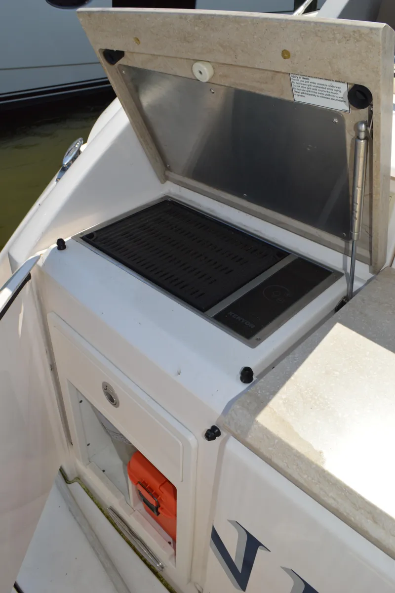 Slide: The Image of Outdoor grill on 2016 Tiara Yachts C44 Coupe, open lid, sleek design. - 20