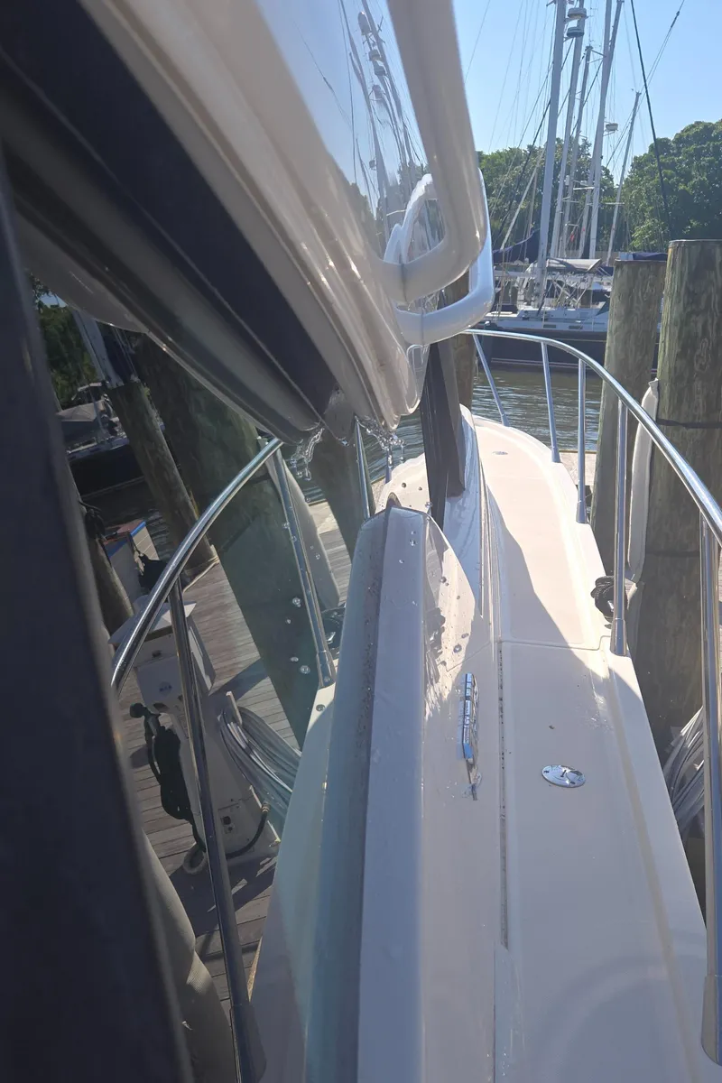 Slide: The Image of 2016 Tiara Yachts C44 Coupe docked, side view with polished deck and railing. - 21