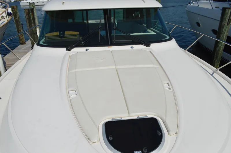 Slide: The Image of 2016 Tiara Yachts C44 Coupe bow view at marina dock. - 23