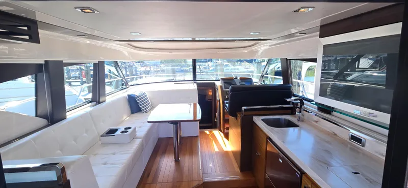 Slide: The Image of Luxurious interior of 2016 Tiara Yachts C44 Coupe with modern seating and kitchen area. - 27