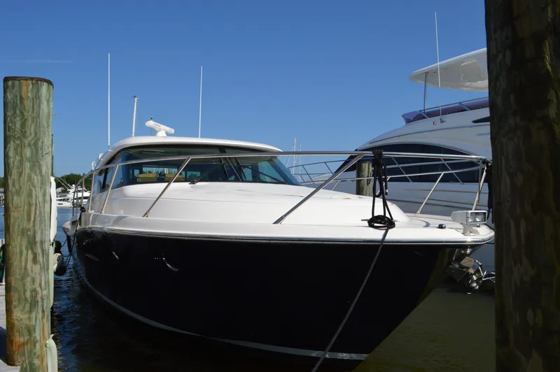 Slide: The Image of 2016 Tiara Yachts C44 Coupe docked at marina under clear blue sky. - 3