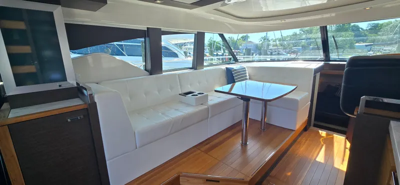 Slide: The Image of Luxurious interior of 2016 Tiara Yachts C44 Coupe with white seating and wooden flooring. - 33