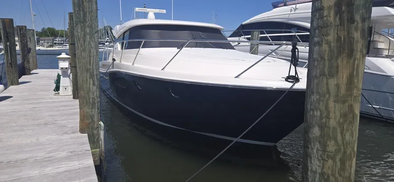 Slide: The Image of 2016 Tiara Yachts C44 Coupe docked at marina, sleek design, sunny day. - 4
