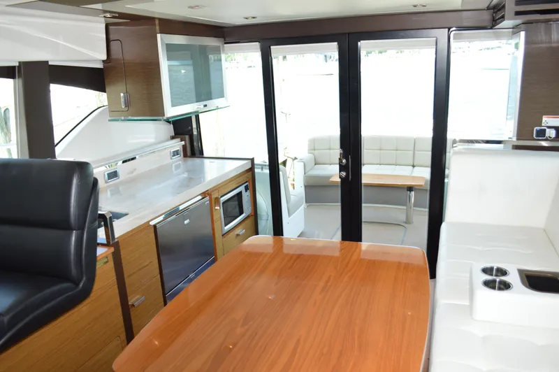 Slide: The Image of Interior of 2016 Tiara Yachts C44 Coupe, featuring modern kitchen and seating area. - 40