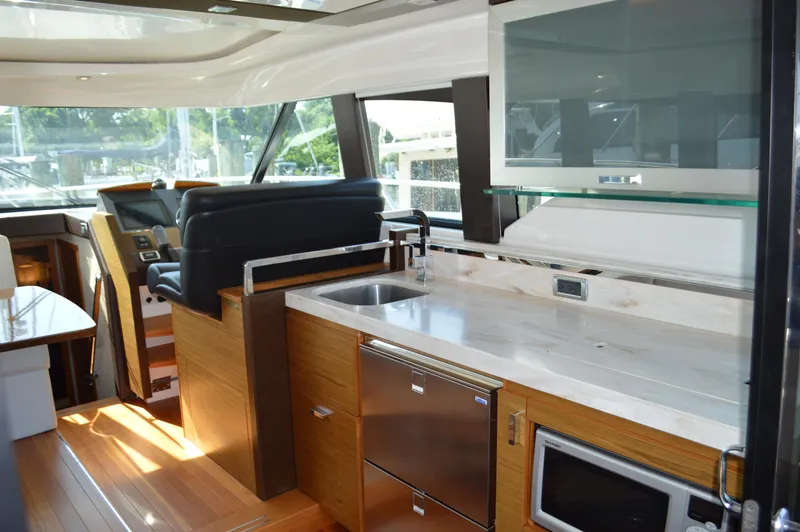Slide: The Image of Luxurious interior of 2016 Tiara Yachts C44 Coupe with modern kitchen amenities. - 41