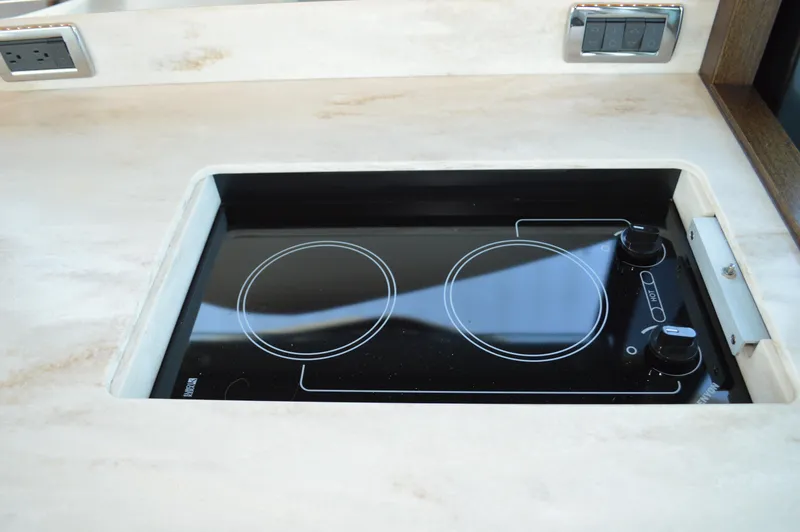 Slide: The Image of Built-in electric stove on 2016 Tiara Yachts C44 Coupe, featuring dual burners. - 46