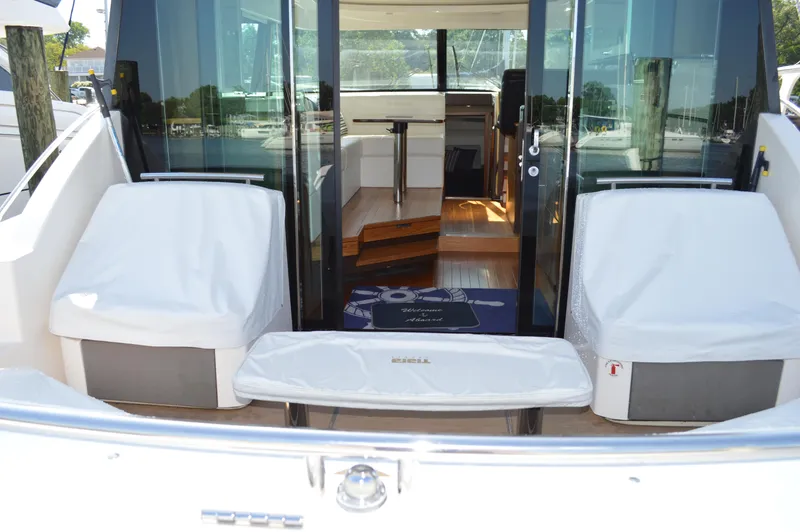 Slide: The Image of 2016 Tiara Yachts C44 Coupe interior view with covered seating and glass doors. - 8